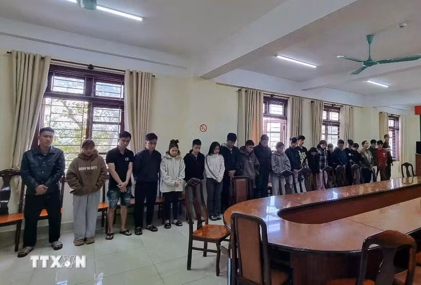 Twenty-two individuals in connection with a sophisticated money laundering operation are prosecuted on March 18. (Photo: VNA)