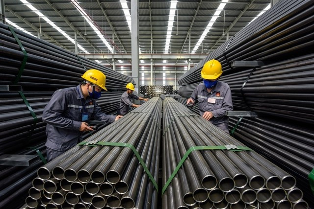 Workers check products at a Hoa Sen Group warehouse. (Photo courtesy of Hoa Sen Group)