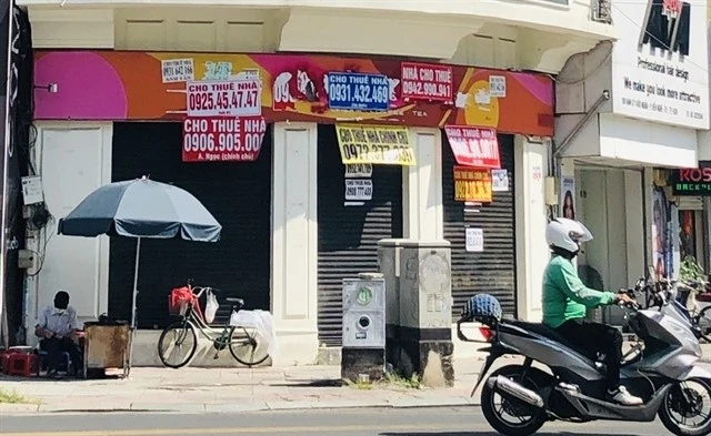 A towhouse in HCM City with banner saying "House for rent". Landlords in the city have cut down rentals due to low demand. (Photo: VNA)