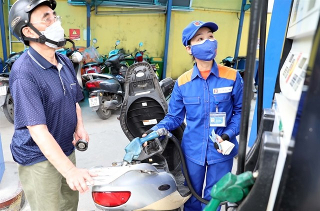 A customer buys petrol at a station in Hanoi. (Photo: VNA)