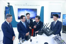 Prime Minister Pham Minh Chinh visits the hall of tradition and technology products of VNPT Group. (Photo: VNA)