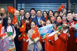 Prime Minister Pham Minh Chinh and his spouse, with Vietnamese Embassy staff and community in Algeria. (Photo: VNA)