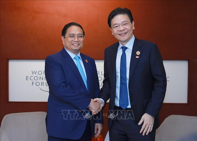 Prime Minister Pham Minh Chinh (L) and his Singaporean counterpart Lawrence Wong in Tianjin on June 25 (Photo: VNA)