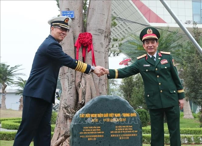 Vietnamese Minister of National Defence General Phan Van Giang (R) and Chinese Minister of National Defence Dong Jun plant a tree at the Huu Nghi International Border Gate. (Photo: VNA)