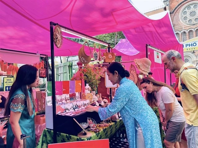 Visitors view accessories for ao dai (Vietnamese traditional dress) at an art programme at the HCM City Book Street in District 1 (Photo courtesy of Book Street Company)