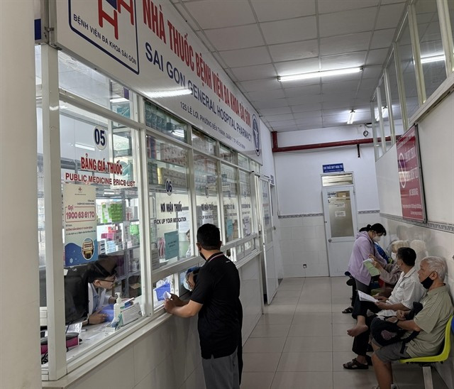 Patients with public health insurance receive medicine at a hospital in HCM City. (Photo: VNA)