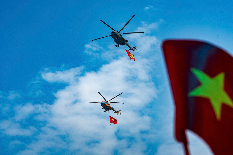 A fleet of helicopters carrying the Party flag and the national flag rehearses over Hanoi ahead of the A80 event. (Photo: VNA)
