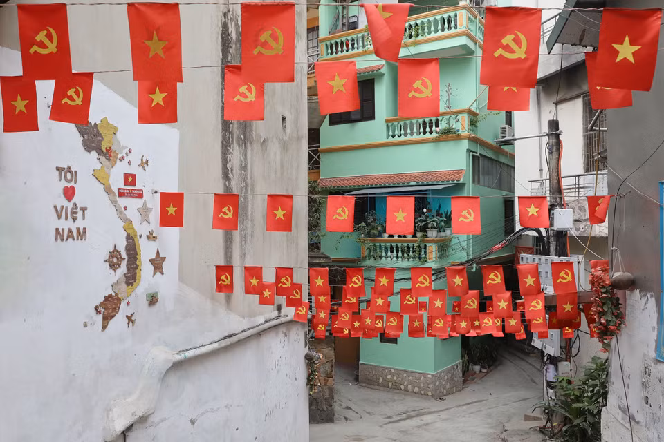 A small alley of Yen Phụ street shines with national flags waving in the wind. (Photo: VNA)