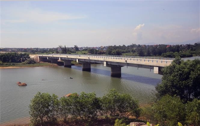 Dinh River Bridge, part of the project that connects Hoan Lao commune with Nam Trach commune, spans about 200 metres and is 12 metres wide, with total investment of 45 billion VND. (Photo: VNA)