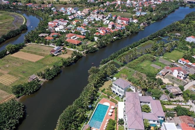 Canals lined with lush nipa palm trees stretch across residential areas in Cam Thanh village. (Photo: VNA)
