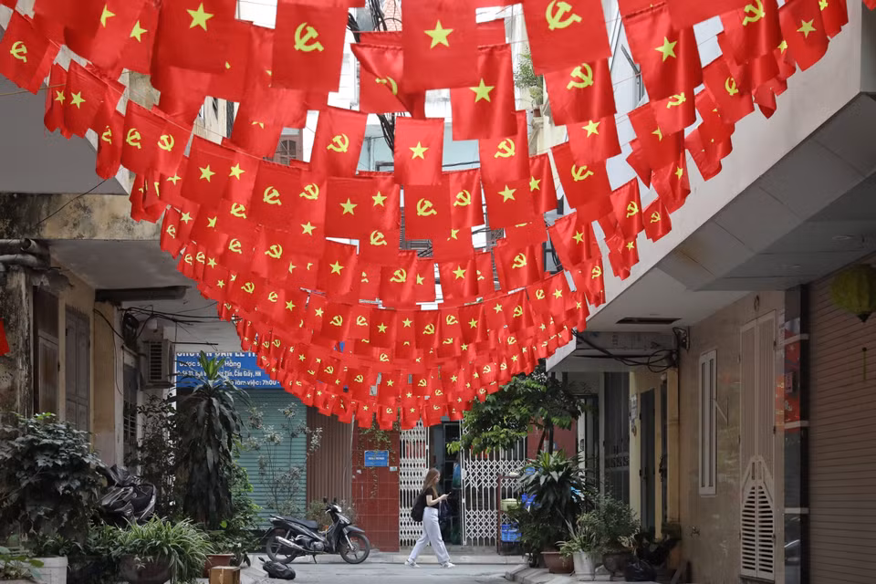 A narrow alley on Nghia Tan street is filled with red flags for the April 30 holiday. (Photo: VNA)