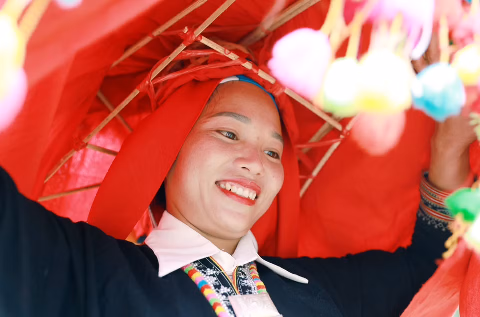 The bride in her traditional costume, with her head covered during the wedding day. (Photo: VNA)