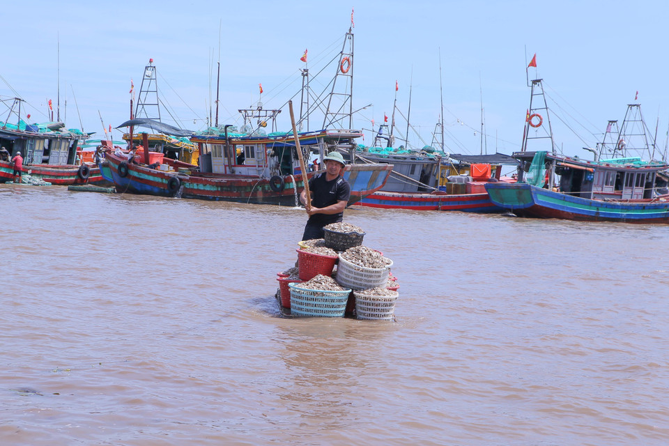 Fishermen use rafts to carry seafood from fishing boats ashore for sale. (Photo: VNA)