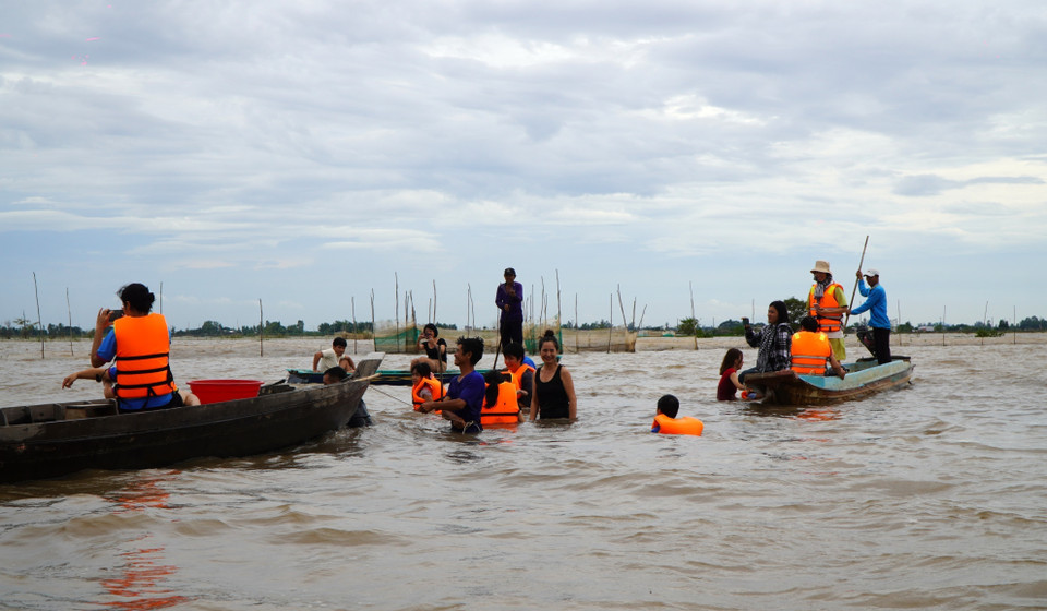 Vast but shallow flooded fields provide ideal conditions for visitors to wade, splash around and have fun. (Photo: VNA)