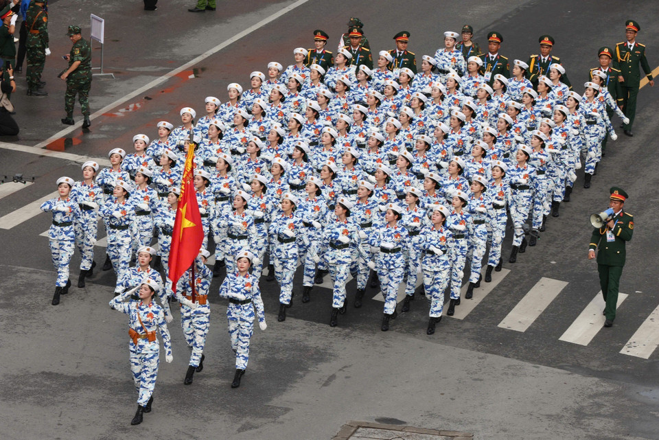 The female military medical unit marches past the Cua Nam five-way intersection. (Photo: Cong Dat - VNA)