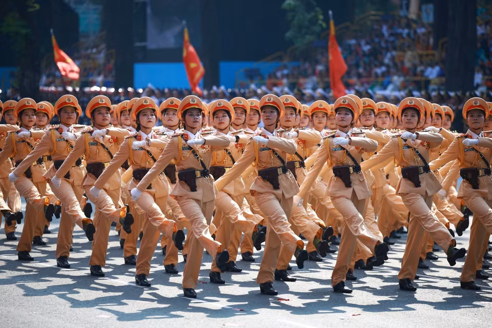The female Traffic Police officers march past the grandstand Photo: VNA