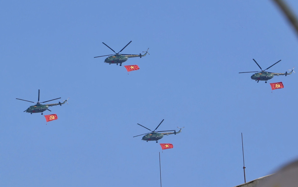 A helicopter formation carrying the Party flag and the national flag flies over the sky of downtown Ho Chi Minh City. Photo: Hong Giang - VNA