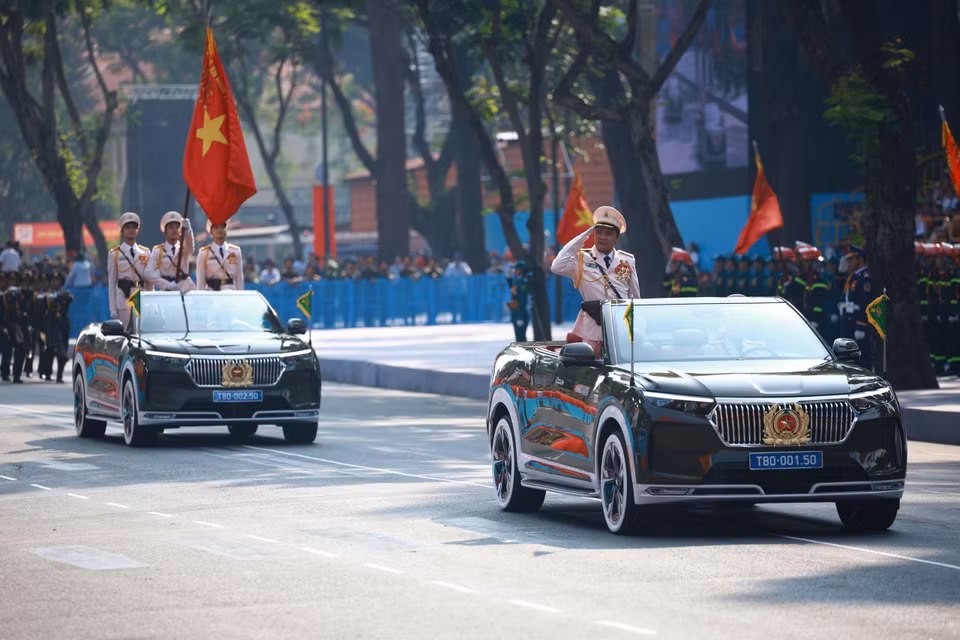The command vehicle and vehicles of the People's Police Force parade past the grandstand Photo: VNA