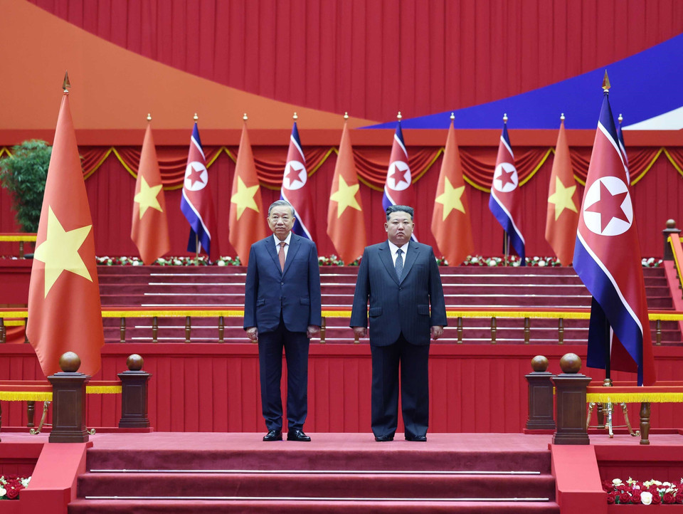 General Secretary To Lam and General Secretary of the Workers’ Party of Korea and President of the State Affairs of the Democratic People’s Republic of Korea Kim Jong Un stand on the ceremonial platform as the military band plays the national anthems of both countries. (Photo: Thong Nhat – VNA)