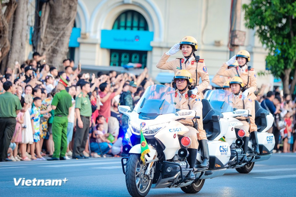 Female traffic police officers salute smartly in formation. (Photo: Hoai Nam/Vietnam+)