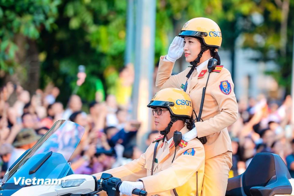 A female traffic police officer salutes smartly in formation. (Photo: Hoai Nam/Vietnam+)