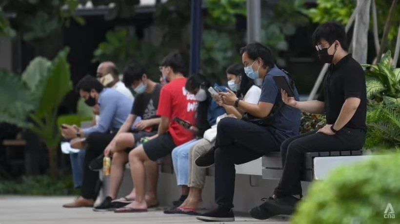 People using their mobile phones. (Photo: CNA/Calvin Oh)