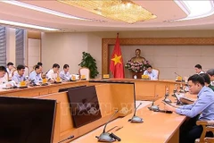 Deputy Prime Minister Nguyen Chi Dung chairs a meeting with ministries, agencies and businesses on September 30 to discuss the implementation of the 11 strategic technology groups. (Photo: VNA)