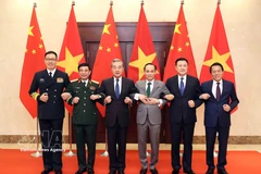 Vietnamese and Chinese ministers pose for a photo at the first ministerial-level Strategic Dialogue among their foreign affairs, defence and public security ministries. (Photo: VNA)