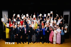 Thirty out of 150 Vietnamese students currently studying at the IMC University of Applied Sciences Krems pose for a group photo with the university's representatives. (Photo: VNA) 