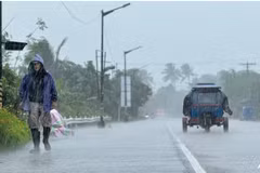 A man walks along a road amid heavy rain due to weather patterns from Super Typhoon Ragasa in Lal-lo town, Cagayan province on Sep 22, 2025. (Photo: AFP)