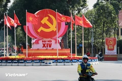 The hammer-and-sickle emblem, the Party flag, and the national flag are prominently displayed at the Dien Bien Phu–Doc Lap–Chu Van An intersection to welcome the 14th National Congress of the Communist Party of Vietnam. (Photo: VNA) 