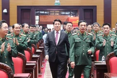 State President Luong Cuong (in black suite) attends the national political-military conference in Hanoi on December 17. (Photo: VNA)