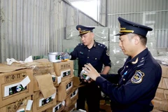 Customs officers of Huu Nghi International Border Gate (Lang Son province) check labels of imported goods at a warehouse in the border gate area. (Photo: VNA)