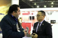 Vietnamese Ambassador to Algeria Tran Quoc Khanh talks with an Algerian businessman at the 7th International Chocolate and Coffee Show in Algeria, on February 4. (Photo: VNA)