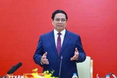 Prime Minister Pham Minh Chinh speaks at a meeting with leaders of Posts and Telecommunications Institute of Technology in Hanoi on April 24. (Photo: VNA)