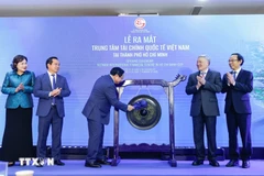 Prime Minister Pham Minh Chinh strikes the gong to inaugurate the Vietnam International Financial Centre in Ho Chi Minh City. (Photo: VNA) 