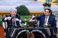 Prime Minister Pham Minh Chinh (R) and Kyrgyz Prime Minister Adylbek Kasymaliev enjoy Vietnamese coffee (Photo: VNA)