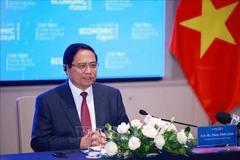 Prime Minister Pham Minh Chinh speaks at the working session with representatives from foreign enterprises in the financial sector (Photo: VNA)