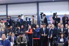 Domestic and foreign journalists cover the 14th National Party Congress (Photo: VNA)
