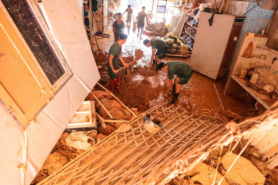 Soldiers from Division 316 help residents of Phuc Khanh commune, Bao Yen district, Lao Cai province clean up their homes after the floods. (Photo: Hoang Hieu - VNA).