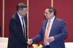 Prime Minister Pham Minh Chinh (right) meets Chairman of the Bank of China (BOC) Ge Haijiao on June 24, 2025. (Photo: VNA)