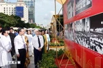 Delegates visit the photo exhibition themed "80 Glorious Years of the National Assembly of Vietnam." (Photo: VNA)
