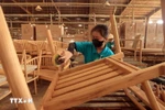 Production of wooden chairs for export. (Photo: VNA)