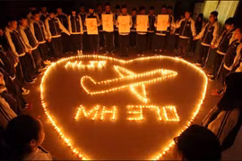 This picture taken on March 10, 2014 shows students at Hailiang International School lighting candles to pray for the passengers on the missing Malaysia Airlines flight MH370 in Zhuji, in China’s Zhejiang province. (Photo: AFP) 