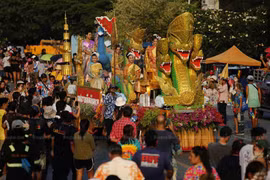 People and performers accompany a float during a Songkran procession through downtown Phra Pradaeng district in Samut Prakan on 21 April 2024. The district typically celebrates Songkran festival a week later than the rest of the country. (Photo: Bangkoko Post) 