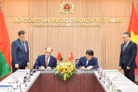 Vietnamese Minister of Public Security General Luong Tam Quang and State Secretary of the Security Council of Belarus Volfovich Aleksandr Grigorievich sign a protocol to establish a joint working group to expand and strengthen cooperation in security. (Photo: VNS)