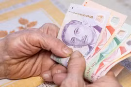 An elderly woman with Singapore dollars. (File photo: iStock) 