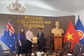 Glenn Mathews and his wife hand over the diary of Vietnamese martyr Vo Van Cong to Minister Counsellor Nghiem Xuan Hoa, representing the Embassy of Vietnam in Australia. (Photo: VNA) 