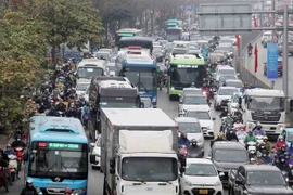 Motorbikes, cars, buses and trucks mingle on Giai Phong street in Hanoi in late January. (Photo: VNA) 