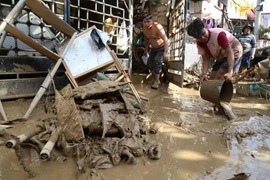 Residents clean up outside their homes after Typhoon Kalmaegi caused devastation in communities at Talisay City, Cebu province, central Philippines, Nov. 5, 2025. (Photo: AP) 